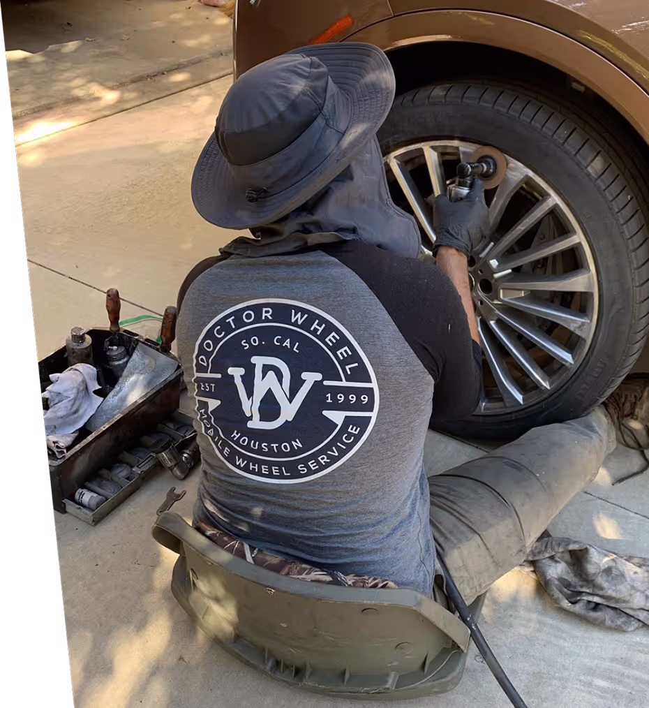 Dr. Wheel technician repairing an alloy wheel curbside with a rotary tool