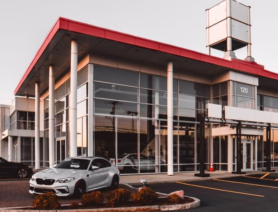 Dealership-style storefront in Houston, Texas with a white car parked outside