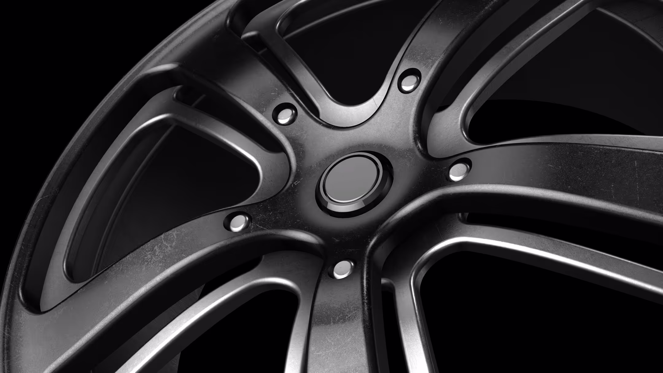 Close-up macro shot of a dark alloy wheel's spokes and center hub