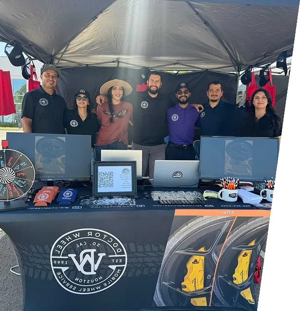 Dr. Wheel team posing together at a branded trade show booth